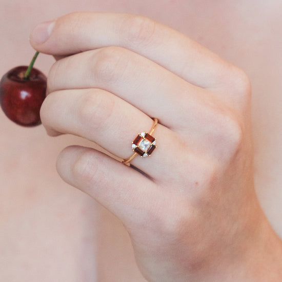LIRAE vintage Art Deco ring with an octagon halo of red garnet baguettes and a white topaz center stone, geometric gold statement ring for women.