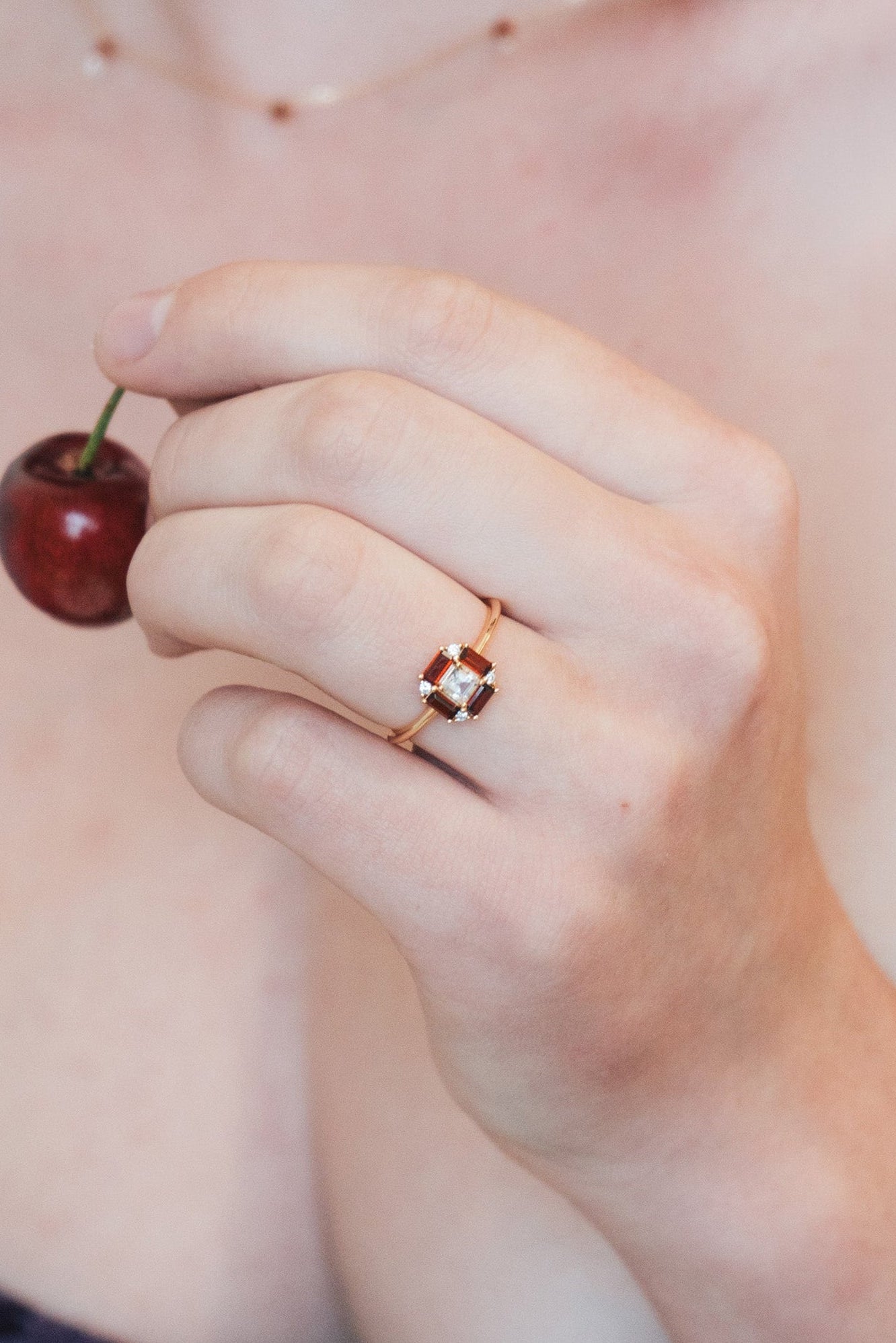 LIRAE vintage Art Deco ring with an octagon halo of red garnet baguettes and a white topaz center stone, geometric gold statement ring for women.
