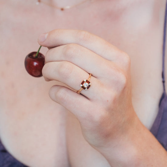 LIRAE vintage Art Deco ring with an octagon halo of red garnet baguettes and a white topaz center stone, geometric gold statement ring for women.