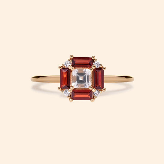 LIRAE vintage Art Deco ring with an octagon halo of red garnet baguettes and a white topaz center stone, geometric gold statement ring for women.