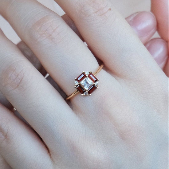 LIRAE vintage Art Deco ring with an octagon halo of red garnet baguettes and a white topaz center stone, geometric gold statement ring for women.