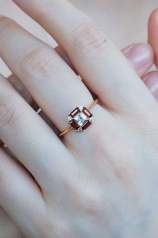 LIRAE vintage Art Deco ring with an octagon halo of red garnet baguettes and a white topaz center stone, geometric gold statement ring for women.