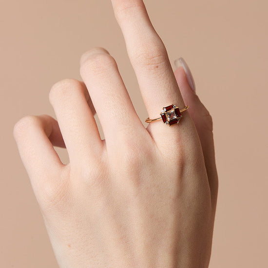 LIRAE vintage Art Deco ring with an octagon halo of red garnet baguettes and a white topaz center stone, geometric gold statement ring for women.