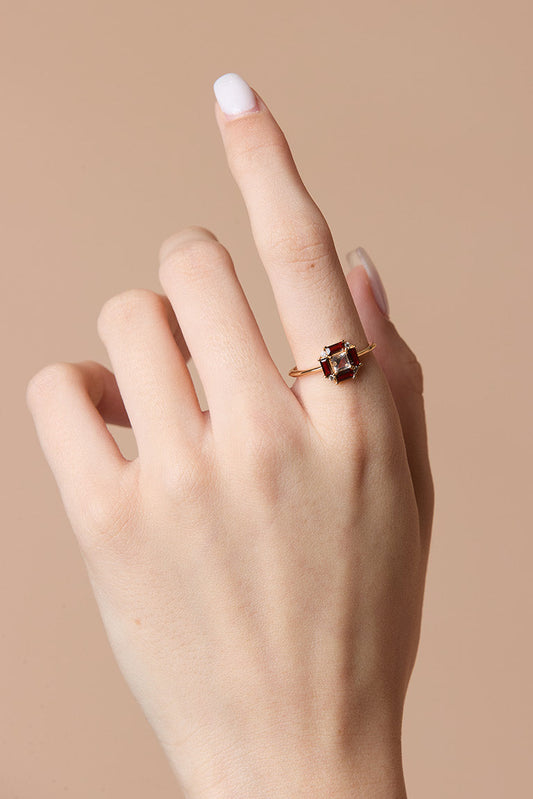 LIRAE vintage Art Deco ring with an octagon halo of red garnet baguettes and a white topaz center stone, geometric gold statement ring for women.