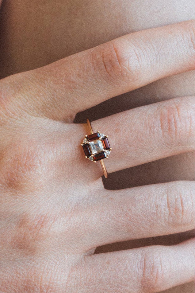 LIRAE vintage Art Deco ring with an octagon halo of red garnet baguettes and a white topaz center stone, geometric gold statement ring for women.