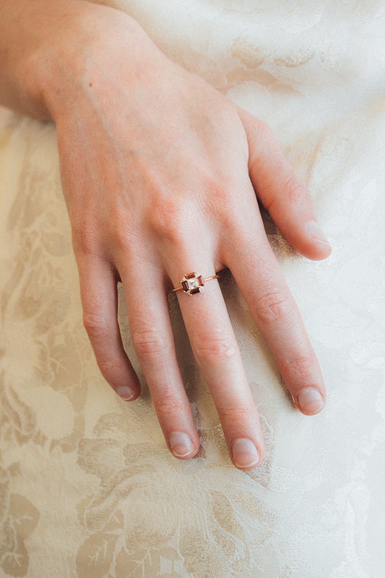 LIRAE vintage Art Deco ring with an octagon halo of red garnet baguettes and a white topaz center stone, geometric gold statement ring for women.