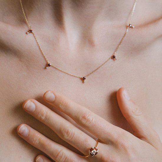 Dainty gold garnet station necklace with sparkling moissanites accents