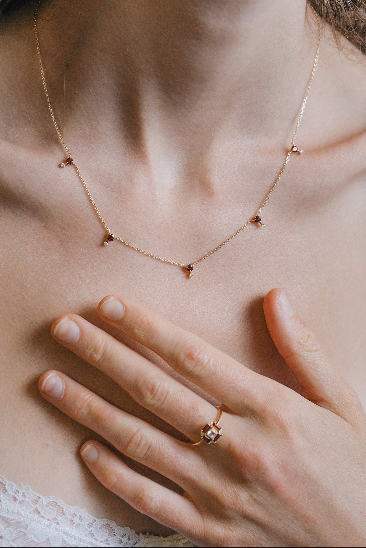 Dainty gold garnet station necklace with sparkling moissanites accents