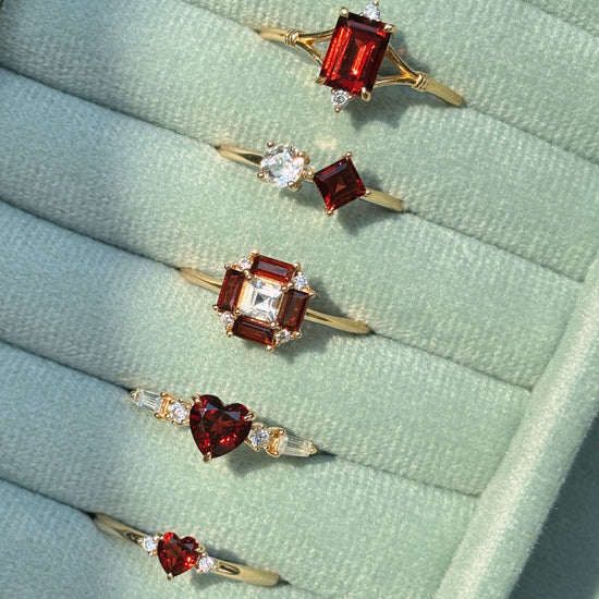 LIRAE vintage Art Deco ring with an octagon halo of red garnet baguettes and a white topaz center stone, geometric gold statement ring for women.