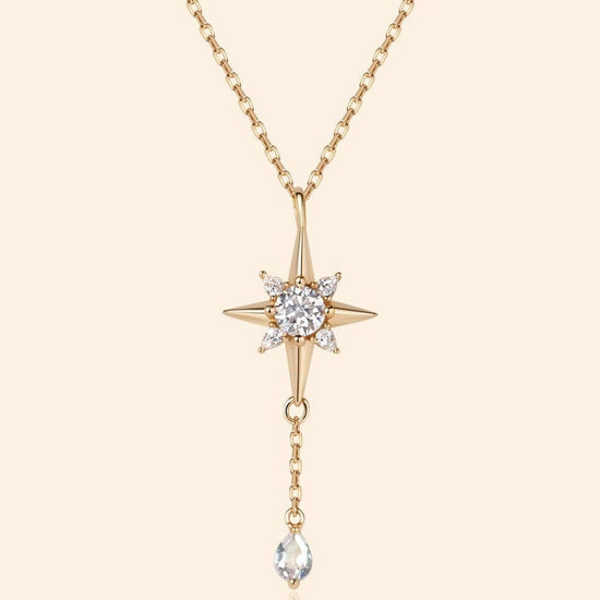 Gold north star necklace with a dangle moonstone.