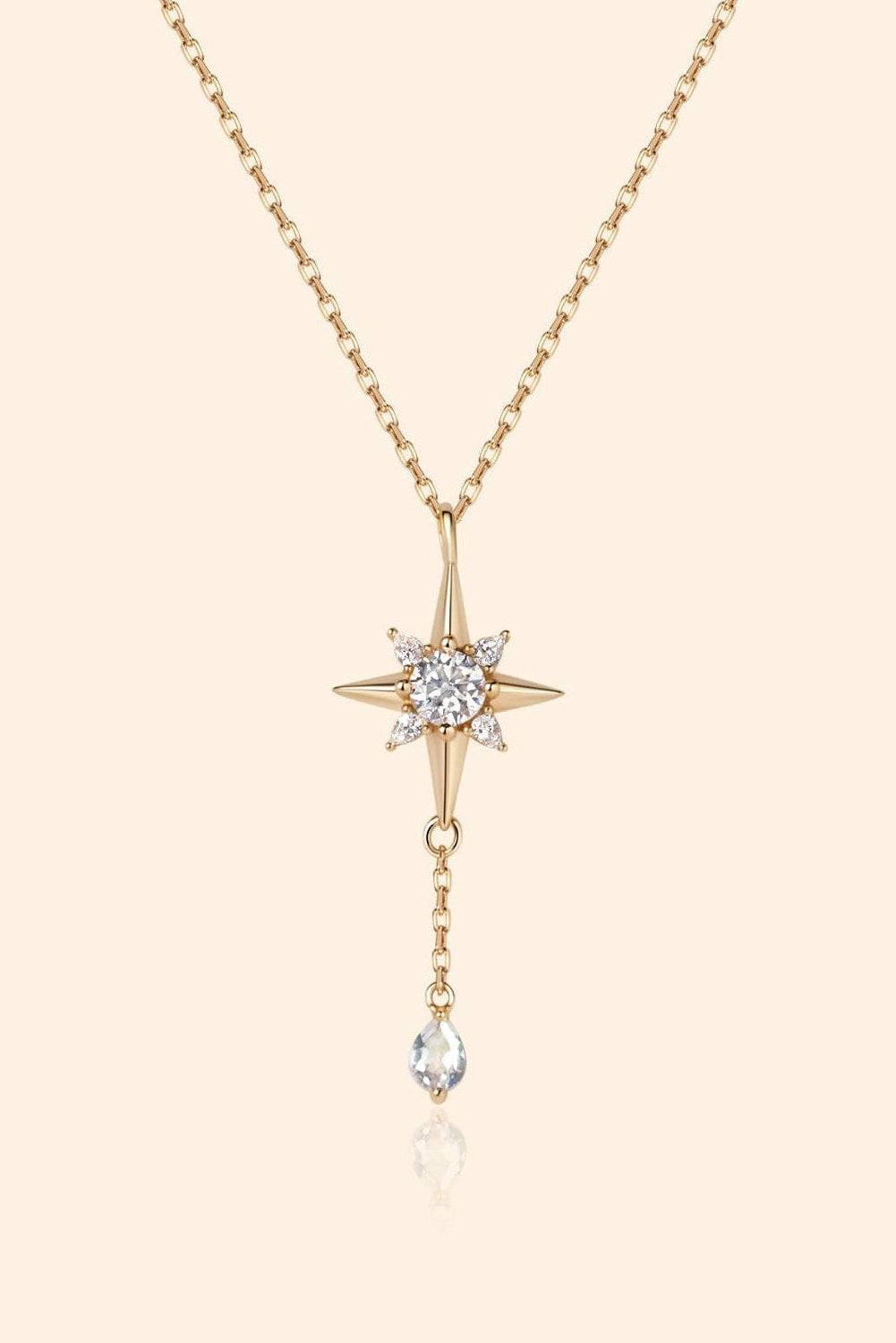 Gold north star necklace with a dangle moonstone.