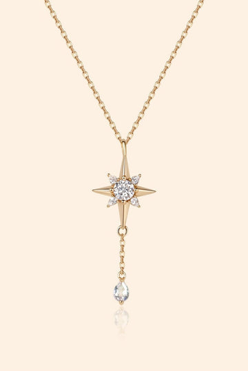 Gold north star necklace with a dangle moonstone.