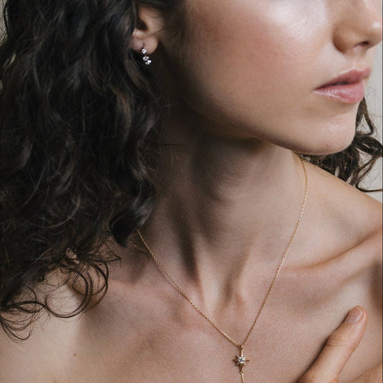 Gold north star necklace with a dangle moonstone.