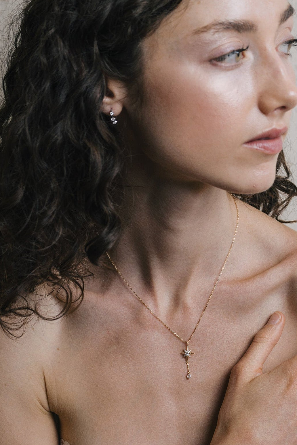 Gold north star necklace with a dangle moonstone.