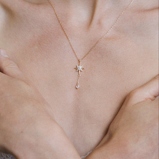 Gold north star necklace with a dangle moonstone.