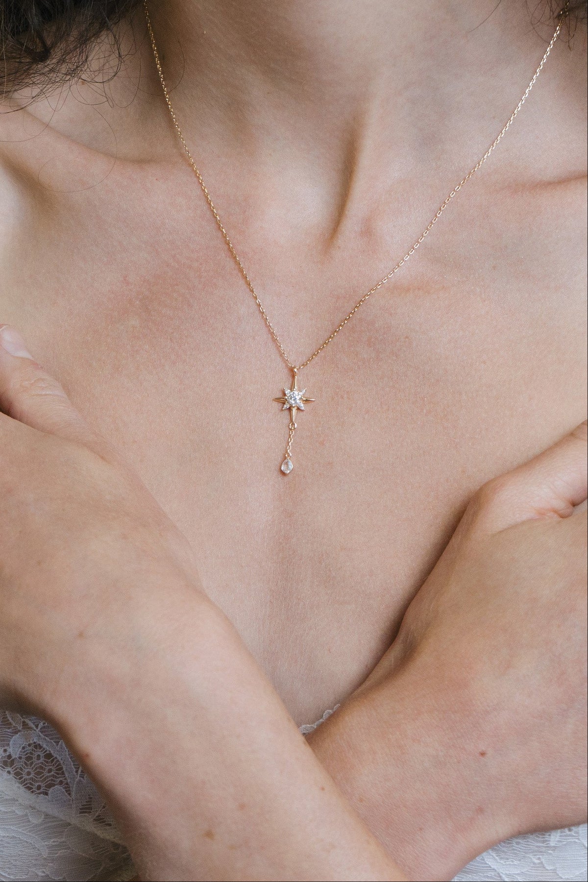 Gold north star necklace with a dangle moonstone.
