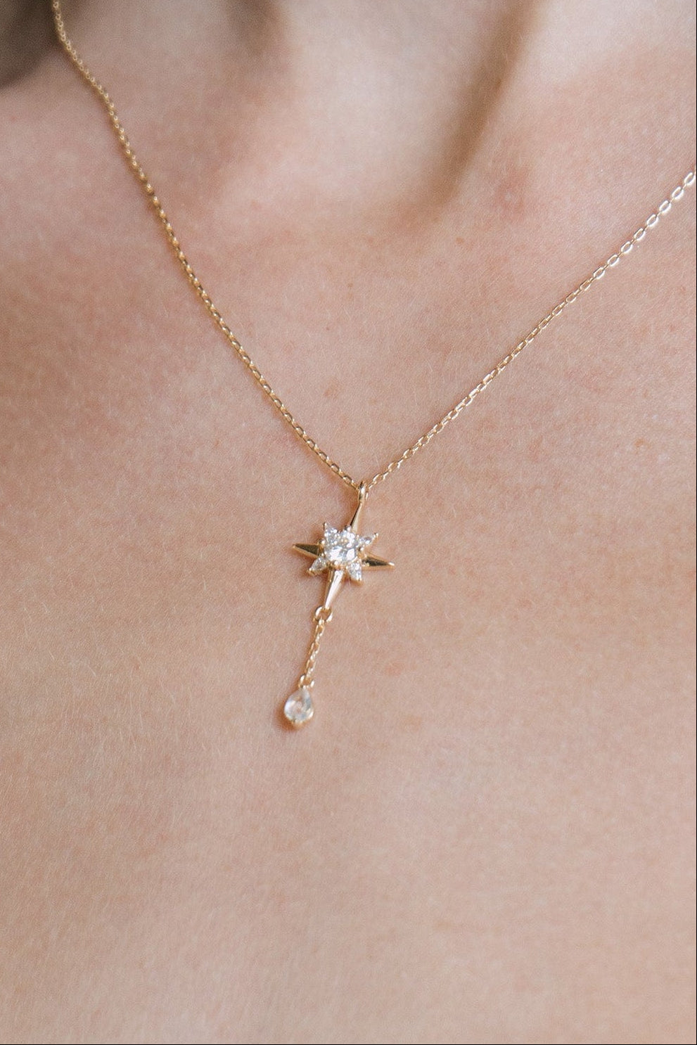 Gold north star necklace with a dangle moonstone.