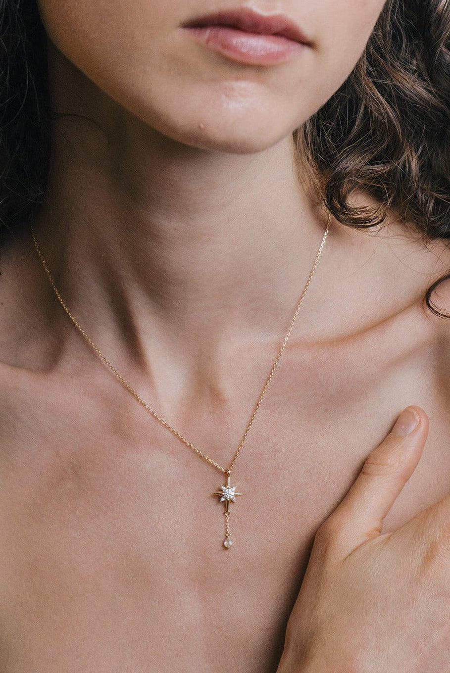 Gold north star necklace with a dangle moonstone.