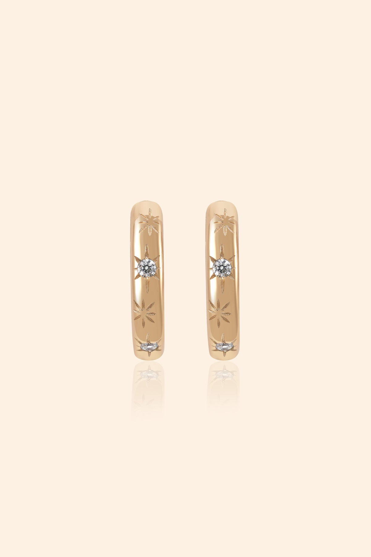 Gold small hoop earrings with engraved star details and moissanites accents