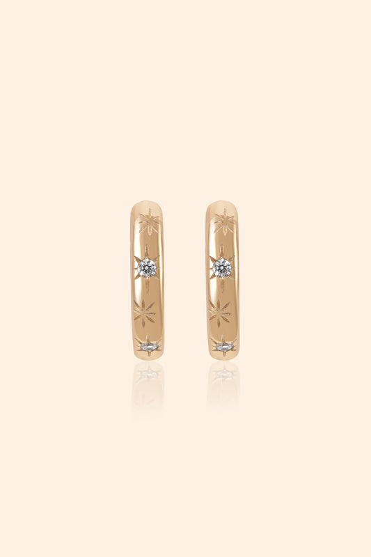Gold small hoop earrings with engraved star details and moissanites accents