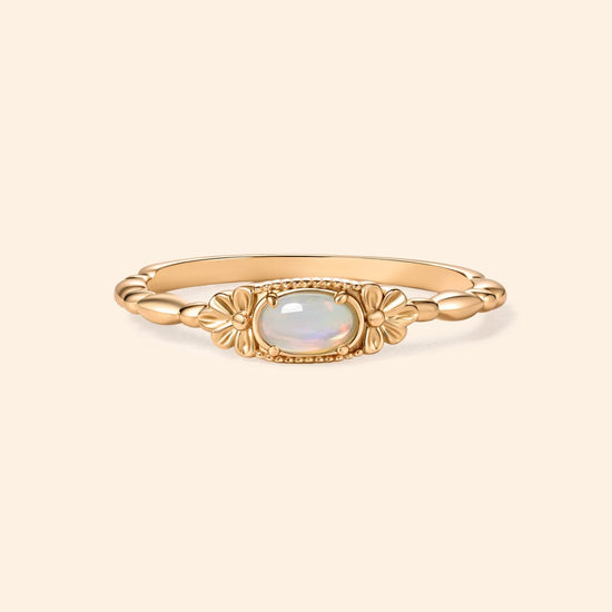 Gold vintage-inspired floral ring with oval opal center stone