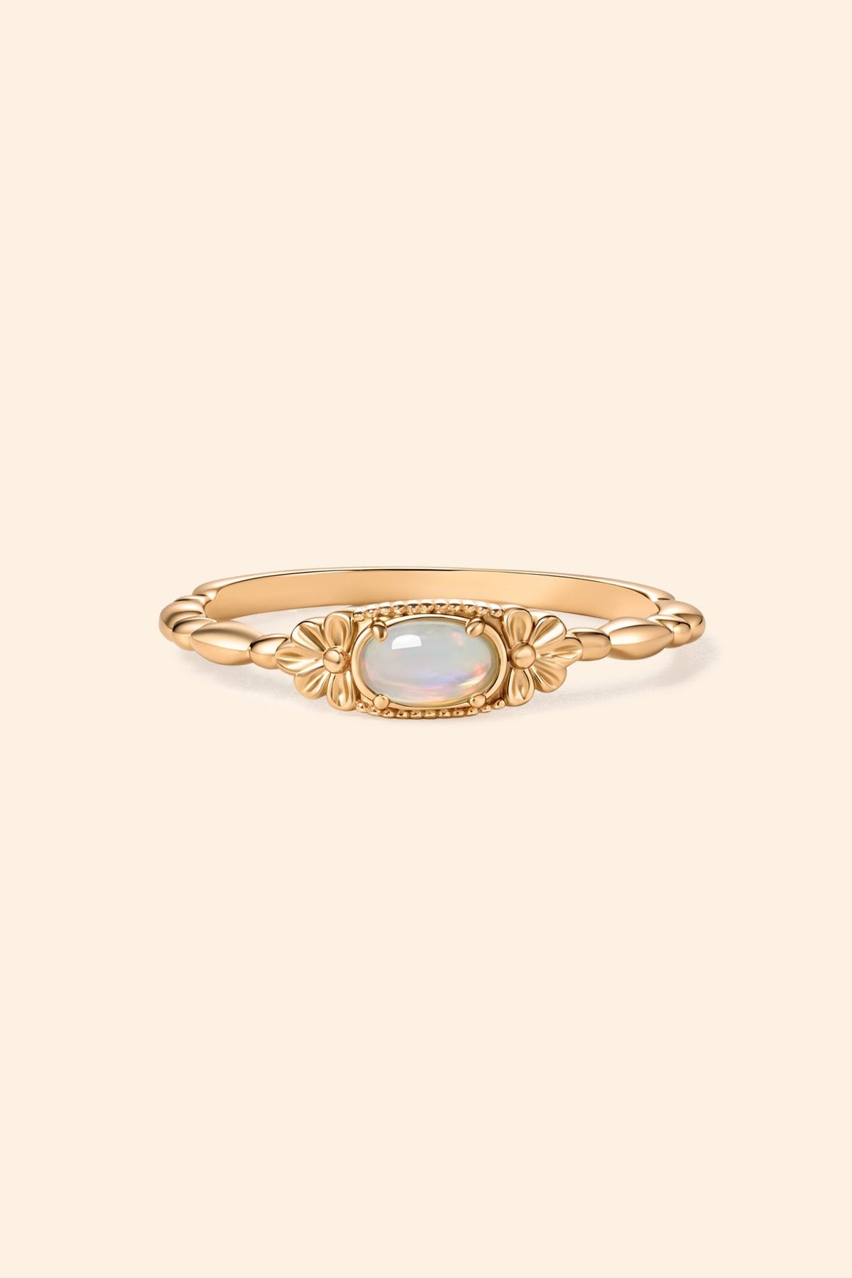Gold vintage-inspired floral ring with oval opal center stone