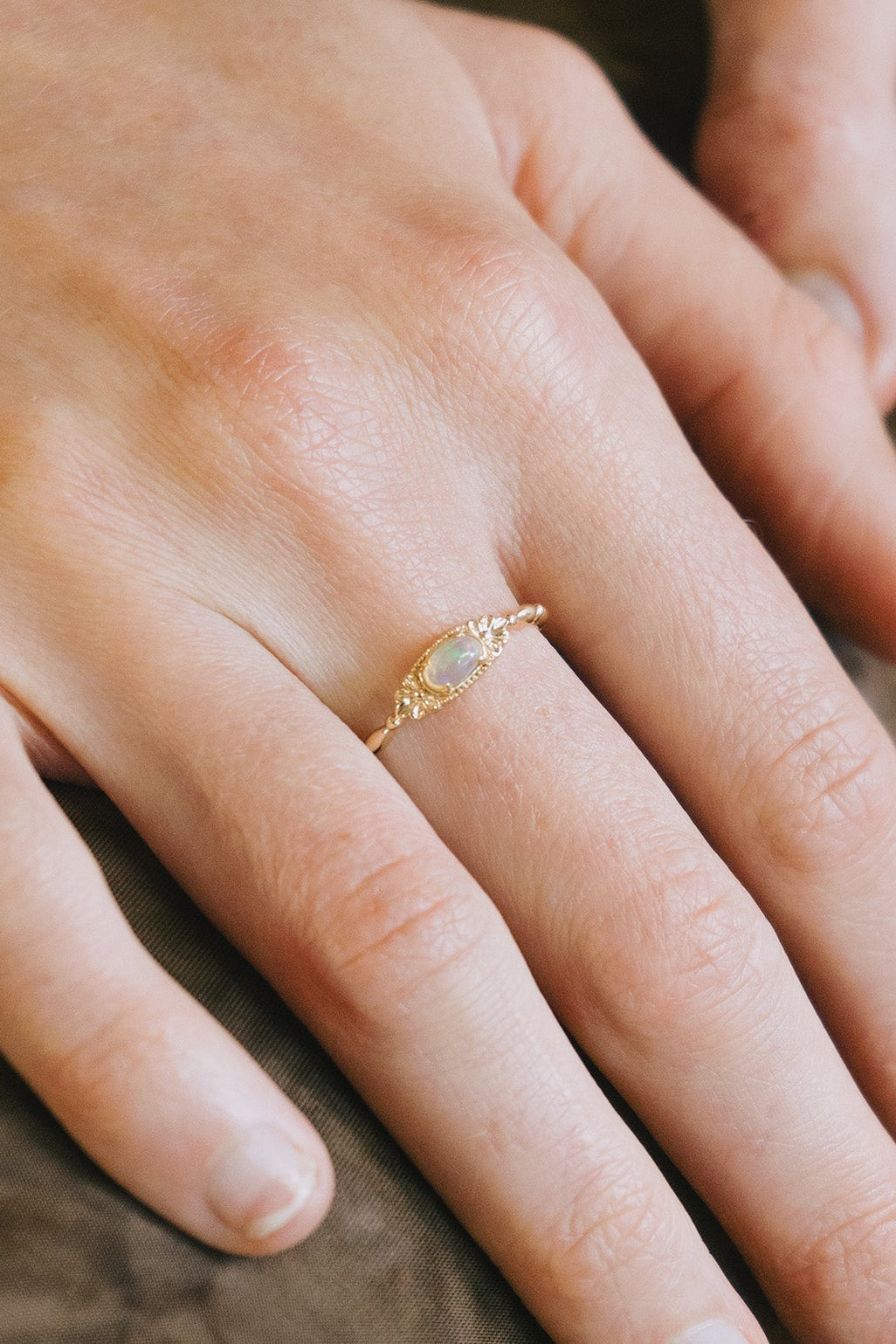 Gold vintage-inspired floral ring with oval opal center stone