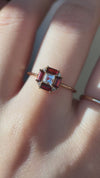 LIRAE vintage Art Deco ring with an octagon halo of red garnet baguettes and a white topaz center stone, geometric gold statement ring for women.