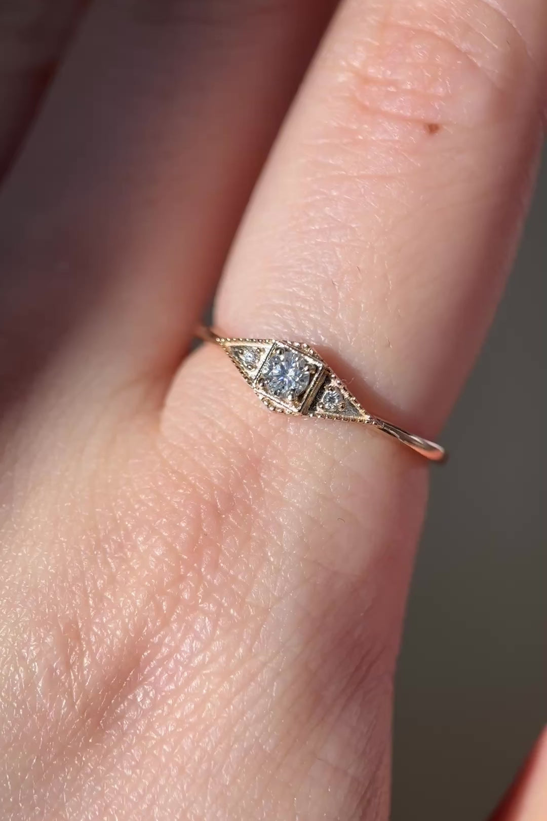 LIRAE Art Deco gold ring featuring a geometric rhombus design with milgrain edges and three moissanites, vintage-inspired stackable jewelry.