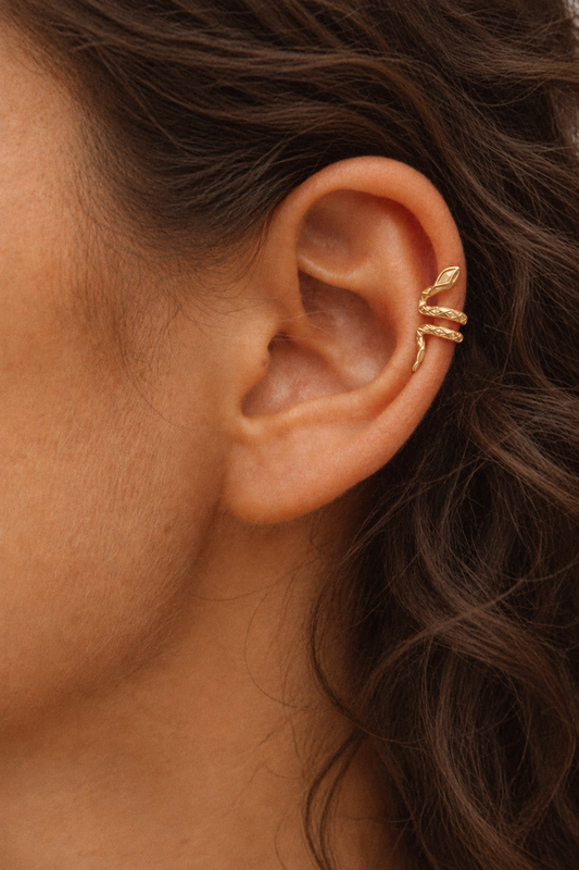 Vesper gold serpent ear cuff featuring a sculptural coiled snake design with intricate textured scales and elegant gold detailing.